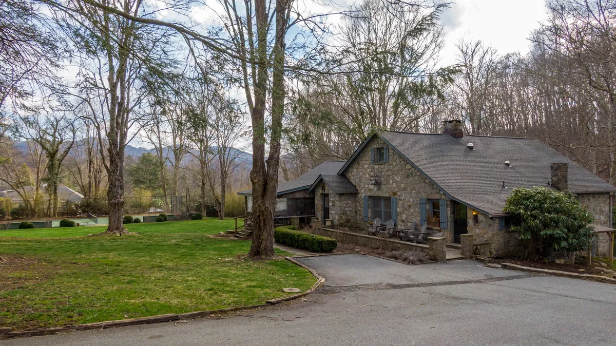 This image shows the stone exterior of Beech Haven, a lush green lawn, and tall trees in the background. The expansive lawn is perfect for outdoor gatherings and nature walks, and the scene highlights the property’s seamless connection to the surrounding natural beauty.